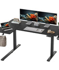 Yihayo 55 Inch L Shaped Electric Standing Desk with dual monitors and laptop on a black surface for ergonomic home office setup.
