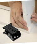 Hand installing space-saving folding hinge set on furniture.