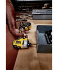 Atomic 20V Max Impact Driver Kit With 1700 In-Lbs Torque in use, demonstrating precision in tight workspace with metal box.