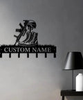 Matte black cast iron personalized gun theme wall hooks for keys and clothes with custom name engraving in a man cave setting.