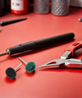 Trendy 100 Piece Mini Buffing Wheel Kit With T-Shaped Design For Drills featuring green and black scouring pads on a work surface.