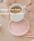 Electric Cup Warmer With Auto Shut Off Timer And Dual Temp Control Keeps Your Morning Brew Cozy On Your Desk With A Bright LED Display top view showing a cup being placed on a waterproof pink warmer.