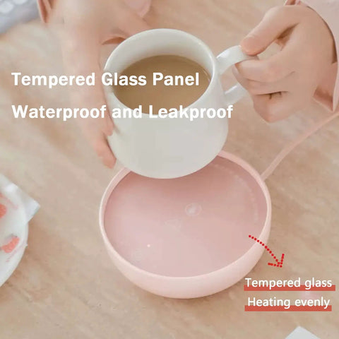 Electric Cup Warmer With Auto Shut Off Timer And Dual Temp Control Keeps Your Morning Brew Cozy On Your Desk With A Bright LED Display top view showing a cup being placed on a waterproof pink warmer.