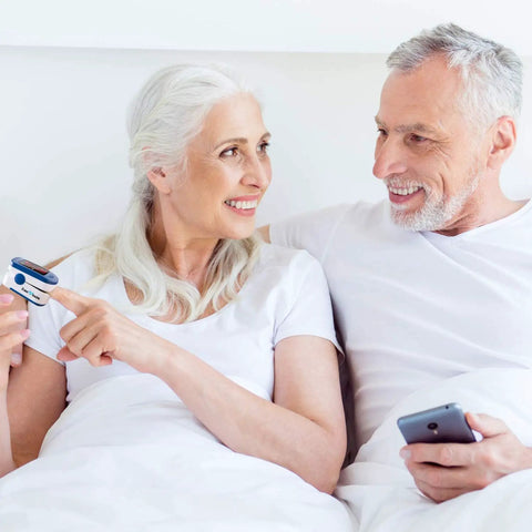 Older couple using Fingertip Pulse Oximeter With Batteries Included For Quick SpO2 And Pulse Rate Readouts, Large LED Display, Navy Blue, Built For Athletes, Travelers, Climbers, Runners And Everyday Health Enthusiasts
