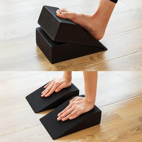 High Grade Foam Yoga Wedge Blocks Set Of Two With Carry Bag shown in use for stretching and balance support on hardwood floor.
