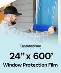 Man applying Blue Window Protection Film 24 Inch By 600 Feet For Construction Self Adhesive Temporary Glass Protection Tape Made In The USA
