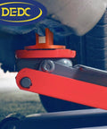 DEDC aluminum grooved jack pad installed under vehicle frame for lifting (orange)