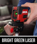 Person adjusting Self Leveling Green Cross Line Laser With Projected Measuring Marks For Quick Precise Layouts Up To 65 Feet A Handy DIY And Pro Tool Red Black LL932401 on tripod