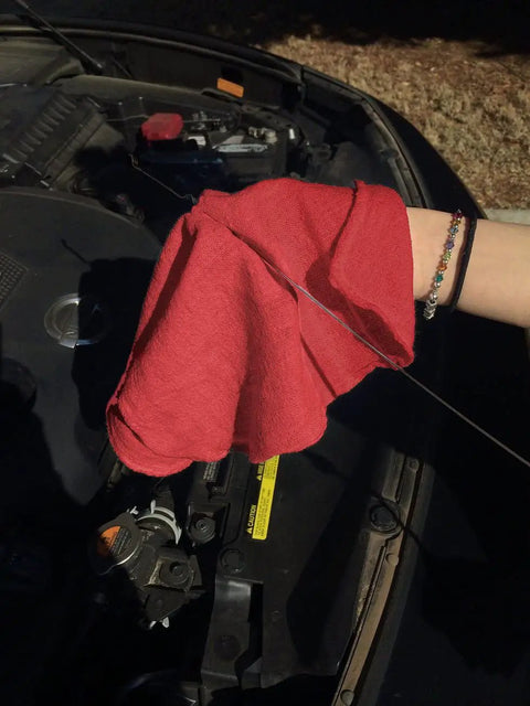 Person using red 150 Pack Cotton Shop Towels Rags 14x12 Inches Absorbent, Reusable Cleaning Rags for Auto Shops on car engine