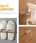 Heavy Duty Adhesive Wall Hooks 30 Pack Straight Up No Drill Setup For Bathroom Kitchen Storage Waterproof Plastic with spray bottles and slippers.