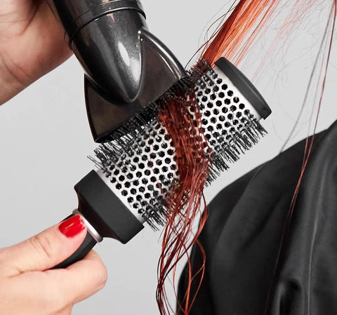 Express Ion Aluminum Round Brush for blow drying all hair types, large vented barrel, corkscrew vegan bristles in use