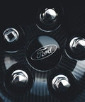 Close-up of Ford wheel with M12x1.50 Chrome Wheel Lug Stud Nut Set For Ford Focus Fusion Fiesta Escape EcoSport Ranger MKC MKZ And More