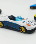 White diecast car with 10 Pack 1/64 Diecast Car Wheels And Tires Set With Mixed Rubber Tires For Custom 1/64 Models, close-up view