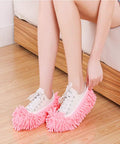 Woman wearing Ultra Soft Microfiber Mop Slippers 5 Pairs 10 Pieces Washable Reusable Floor Cleaning Shoes Covers No Sweat Easy Clean Chenille Foot Socks Eleven By Four Point Seven Inches Adjustable Color Purple Green Pink Blue Orange, in pink color.