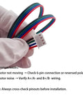 4 Pack Nema 17 Stepper Motor Cables With Ridiculously Slick XH2.54 To PH2.54 Plugs 500Mm Length in hand, showing wiring details.