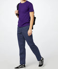 Original Straight Leg Work Pants Built Solid As A Rock With The Roomy Big And Tall Fit Stone Cold Durable Polyester Cotton Blend Resists Wrinkles And Grease Spills Perfect For The Job Site Or Daily Office Hustle Navy Shade worn with a purple t-shirt.