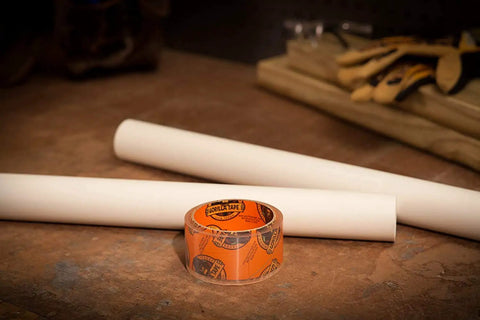 Crystal Clear Heavy Duty Duct Tape 1.88 Inch By 9 Yard Weatherproof All Purpose Tape on workbench with tools in background.