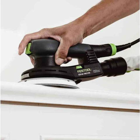 Hand using Topshelf Random Orbit Sander With Stepless Speed Control on wood surface for smooth finishing.