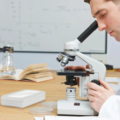 Scientist using microscope with Pro Grade 0.01mm Microscope Calibration Slide Ruler With Stage Micrometer Glass Reticle Ruler Dual Scale nearby