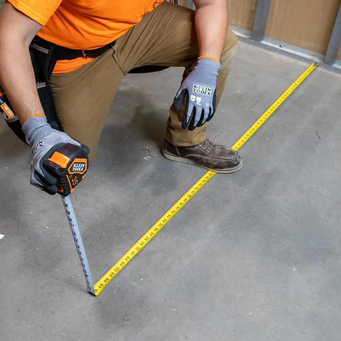 Person using 9235 Heavy Duty Magnetic Tape Measure With 16 Foot Reach, Double Hook, Double Sided Nylon Reinforced Blade on floor