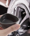 Hand holding 4 Pack Trailer Wheel Bearing Rubber Caps 1.98 Inch For Water Protection And Easy Install Beefed Up Hub Seal Caps Fits Most Wheel Hubs Keeps Dirt Out And Protects Shafts near tire.