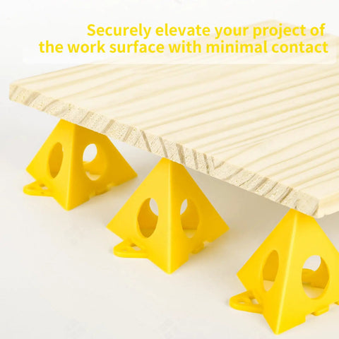 Premium Solid Gold 36 Piece Painters Pyramid Stands For Cabinet Doors And Furniture Risers elevating wood panel with yellow tripod cones.
