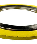 Front view of a spiral-wound gasket with a yellow outer ring and silver inner bore; 34 in pipe size.