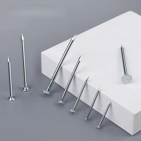 400 Piece Picture Hanging Nails Set With Five Sizes Up To 2 Inches displayed on white surface, showcasing silver galvanized nails.