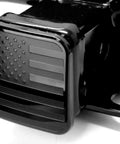 Black Metal Flag Trailer Hitch Cover For 2 Inch Receivers on vehicle, American flag design, heavy-duty aluminum and rubber