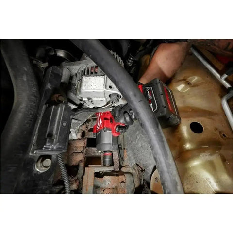 Mechanic using M18 FUEL 1/2 Inch Hi Torque And 3/8 Inch MTIW Automotive Combo Kit Red 3010-22 on car engine in garage