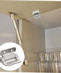 Cabinet door damping hinge installed on beige cabinet; metal hinge hardware shown, inset close-up.