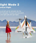 Pro Level RC Airplane For Adults, 2.4G 6CH Glider With 3 Flight Modes flying in vertical mode over scenic landscape.