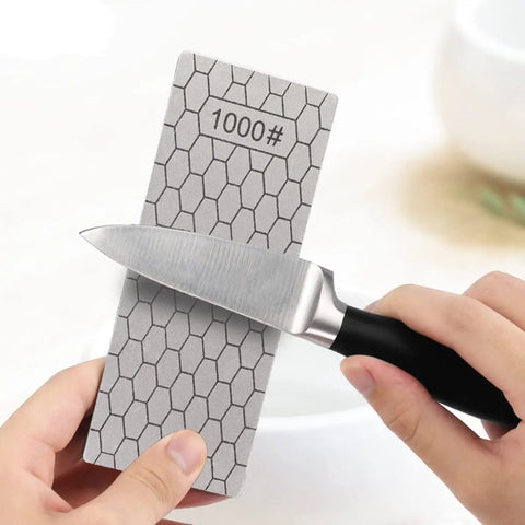 Person sharpening knife on All In One Diamond Sharpening Kit With Honeycomb Surface And Non Slip Base Pro Grade Nine Grit Range 240 To 3000 With Angle Guide And Leather Strop For Knives Scissors And Tools