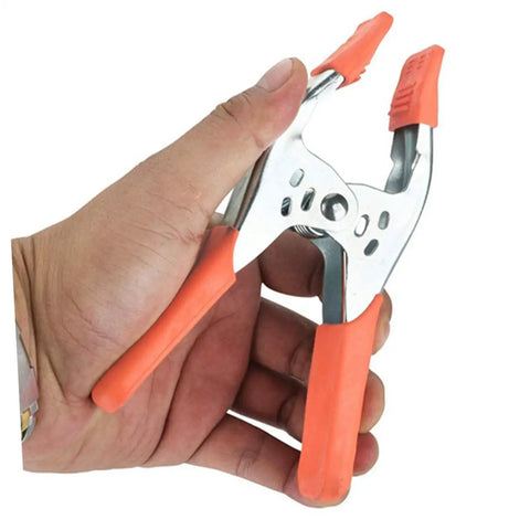 Heavy Duty Metal Spring Clamps With Ergonomic Handles Built Tough For Woodworking Carpentry And Model Making Red Coated Shop Essentials Straight Up Dependable Workhorse in hand with comfort grip