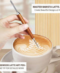 Hand using rosewood latte art pen to design a coffee in a white cup on a table