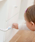 Three Pack White Refrigerator Cabinet Locks No Punch Design Easy Install on drawer with child nearby