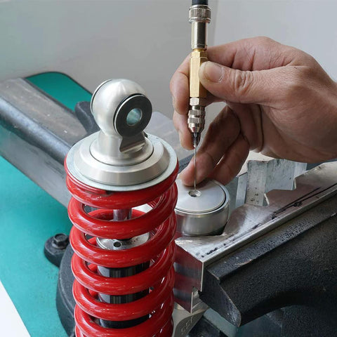 NICECNC nitrogen needle kit with needle head used on a red coilover shock, hand guiding the needle.