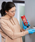 Person applying Smart Dispenser Gap And Crack Foam Sealant Cream 12 Ounce For Drafts And Leaks around light switch
