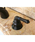 Side view of oil-rubbed bronze bathroom faucet handle on marble countertop