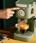 Heavy Duty No Hassle Electric Cappuccino Maker With Smooth Pour Milk Frother and Quick Adjust Brew Settings Removable Drip Tray, finger pressing brew button.