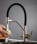 GAZOGJ 3-Way Kitchen Faucet with 360°Rotating Extendable Shower Head, sleek design with a black and chrome finish, used for washing vegetables.