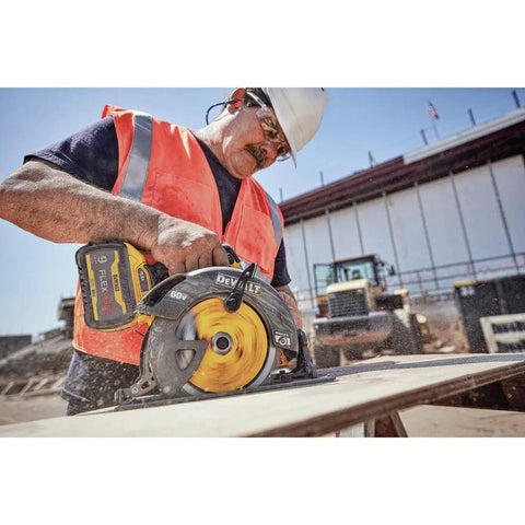 Worker using Flexvolt 60V Max Cordless Circular Saw With Brake 7-1/4 Inch, cutting wood on a construction site.