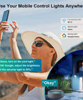 Woman using phone to control Smart Outdoor Security Flood Light With Motion Sensor, WiFi App, Alexa, Google integration.