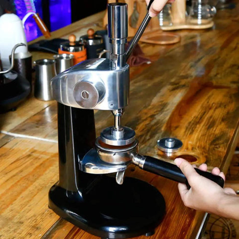 Gotta Have This Straight Fire Pro Grade Stainless Steel Coffee Tamper With Accurate Dial Gauge in use at a cafe.