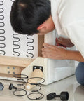 Person repairing a sofa using Rock Solid Heavy Duty Tension Springs 4 Pack Sofa Replacement Parts Fix Couch And Recliner Fast High Strength Steel Clip Kit For Bed Frame Repair Built Tough 3.93 Inch Super Durable Support Boost.
