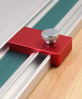 Close-up of a Two Pack Aluminum Guide Rail Limit Stop for Track Saws in red, attached to a metal rail.