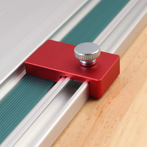 Close-up of a Two Pack Aluminum Guide Rail Limit Stop for Track Saws in red, attached to a metal rail.