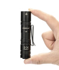 Rechargeable 1200 Lumen EDC Flashlight With Clip AA Pocket Light held between fingers, showing compact black design