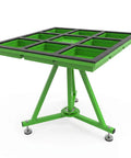 Top Shelf 360 Degree Spin Workbench Galvanized Steel Industrial Assembly Table With Smooth Swivel Base And Tough PVC Shield For Shop Floor Or Packing Bay Five Piece Heavy Duty Rig green swivel workbench with multiple compartments and sturdy base.