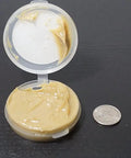 Open container of Universal Reel And Star Drag Grease For Fishing Reels Multi Use Lubricant 1 Pound Tub Tan Finish with quarter for scale
